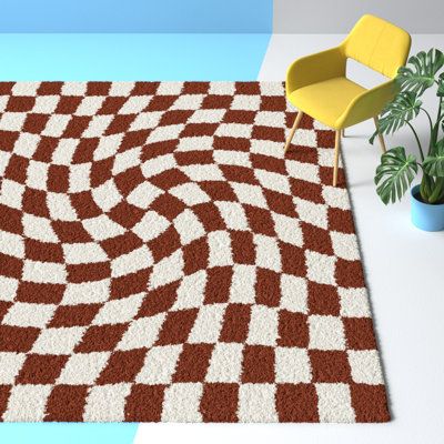 This indoor area rug adds a plush foundation to any space while bringing an eye-catching design that's full of contemporary style. A swirling checkerboard pattern comes in rust and white tones for a retro-mod feel wherever you roll it out. Power-loomed from stain-resistant polypropylene, this rug's high 1.18" pile height provides ample cushion to low-traffic areas like your home office or bedroom. Even though it has a backing, we recommend pairing it with a rug pad (sold separately) to keep it f Rust Checkered Rug, Navy And White Rug, Burnt Orange Living Room, Big Girl Bedrooms, Living Room Orange, Cheap Rugs, Checkered Rug, Checkerboard Pattern, Shag Area Rug