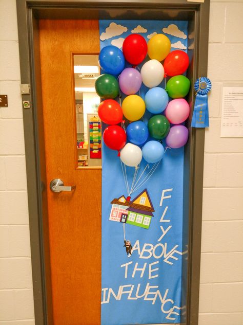 Teacher Door Decorating for red ribbon week. UP movie theme: "Fly Above the Influence." End Of The Year Classroom Doors, Back Door Decorating Ideas, Disney Teacher Door, Graduation Door Decorations Classroom, Pixar Decorations Ideas, Graduation Door Ideas, Lego Door Decorations Classroom, Graduation Classroom Door, Disney Classroom Door Ideas