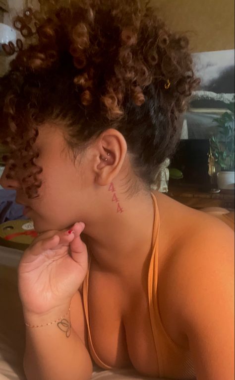 Light skinned curly haired girl’s side profile showing the daith piercing in her ear and 444 tattoo in red ink right behind ear Behind Ear Tats Angel Number, 444 Tattoo With Butterfly Behind Ear, 4444 Angel Numbers Tattoo Behind Ear, Small 444 Tattoo Behind Ear, 888 Behind Ear Tattoo, Baddie Ear Tattoos, 555 Behind Ear Tattoo, 222 Ear Tattoo, Red Ink Tattoo Ideas Female