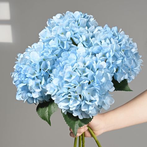 PRICES MAY VARY. 💙Realistic Flowers & Leaves: Elevate your floral arrangements with our pack of 4 vivid blue hydrangeas with vivid leaves. Standing at an elegant height of 18 inches, a great addition to your flower arrangement. 💙Full & Realistic Hydrangeas: With our silk-crafted hydrangea artificial flowers, each fake flower boasts 96 petals, offering a full and vibrant presence, perfect for table centerpieces destined to capture attention. Prepare to receive numerous compliments on how beauti Blue Hydrangea Flower Bouquet, Hydrangea Blue Bouquet, Fake Hydrangea Arrangements, Blue Hydrangea Bouquet Wedding, Maleficent Oc, Hydrangea Corsage, Teal Blue Flowers, Party Decor Outdoor, Baby Blue Flowers