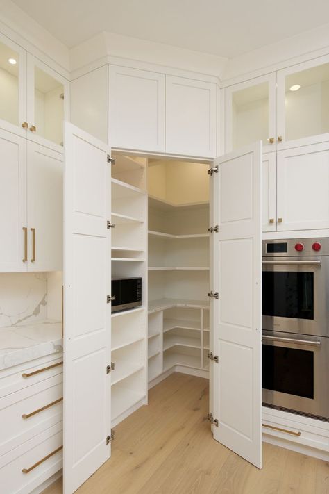 Walk-in white double-door corner pantry with floor to ceiling shelving, a microwave and gold handles. Corner Kitchen Pantry, Pantry Closet Design, Built In Pantry, Desain Pantry, Corner Pantry, Pantry Remodel, Kitchen Pantry Design, Kitchen Design Plans, Kitchen Room Design