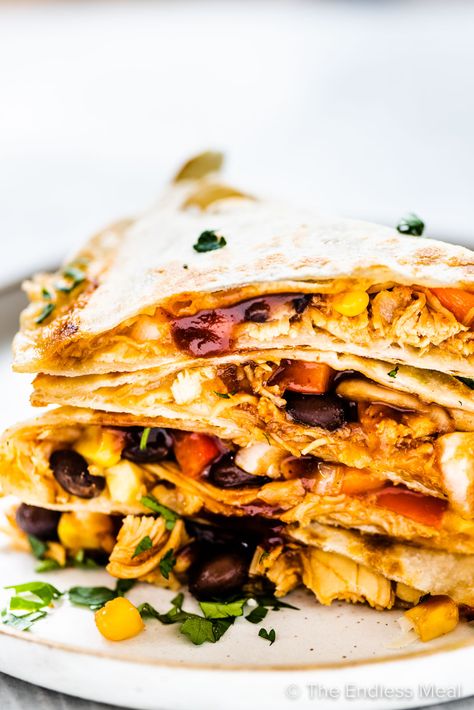 PIN TO SAVE FOR LATER! This is the ultimate chicken quesadilla recipe. Loaded with saucy bbq chicken, lots of melty cheese, and Tex-Mex favorites like corn, black beans, and bell peppers, they are always a winner. You'll love how quick and easy they are to make! #theendlessmeal #chickenquesadilla #quesadillas #chicken #mexican #mexicanrecipes #easyrecipes #texmex #texmexrecipes #familyrecipes #appetizers #gameday #gamedayrecipes #tacos #fajitas #bbqchicken Easy Chicken Quesadilla Recipe, Quesadillas Chicken, Bbq Chicken Quesadilla, Cheese Quesadilla Recipe, Chicken Mexican, Chicken Quesadilla Recipe, Quesadilla Recipe, Easy Guacamole, Quesadilla Recipes