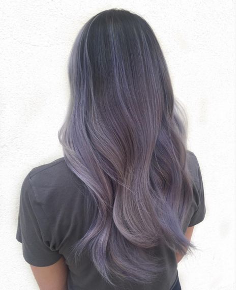 If you like ombre styles and unnatural shades, we've got a beautiful new hair color for you: smoky lilac. As seen in this sweeping look by hairstylist Kendall Noel, smoky lilac hair transitions from a deep grayish purple down to a pale, foggy lavender. The result: a mysterious, unique shade that looks especially lovely on longer hair. Lilac Hair Color, Rainbow Hair Color, Hot Hair Colors, Lilac Hair, Hair Color Pastel, Lavender Hair, Hair Color Purple, Pastel Hair, Ash Blonde