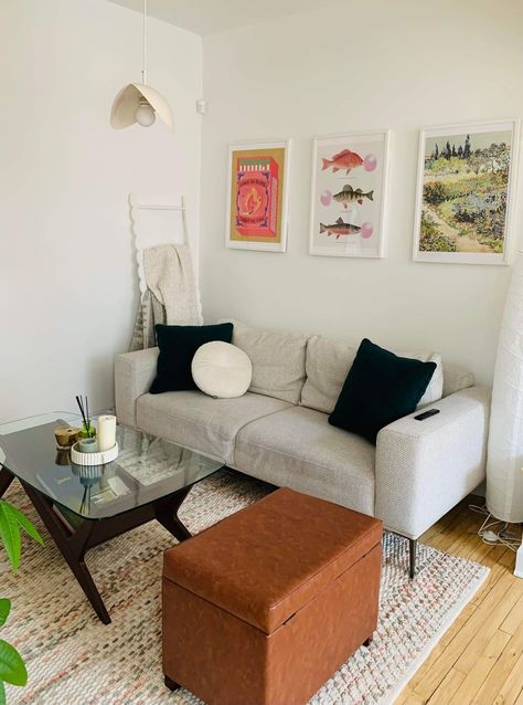 A living room with a white sofa and three framed posters above Posters Above Couch, Living Room Artwork Above Couch, Above Couch Decor Ideas, Over Tv Decor, Pictures Over Couch, Frames Above Couch, Artwork Above Couch, Couch Decor Ideas, Art Over Sofa