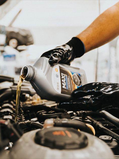 a person pouring oil into a car engine Car Mechanic Aesthetic, Mechanic Photography, Mechanics Photography, Oil Change Service, Car Oil Change, Mechanics Aesthetic, Automobile Advertising, Car Oil, Auto Mechanic