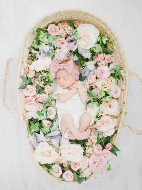 Newborn with cute pink bow in a basket with flowers Flower Crown Newborn Photos, Newborn Photography Dried Flowers, Floral Newborn Photoshoot, Newborn Tea Party Photography, Newborn Photoshoot Flowers, Flower Newborn Pictures, Wreath Newborn Photography, Newborn Spring Pictures, Newborn With Flowers