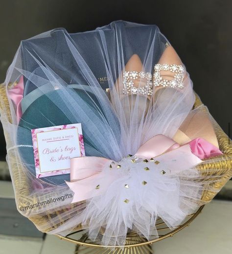 Bride’s shoes and bags wrapped in white and peach for engagement dowry wrapping. Shoes Packing Ideas For Gift, Engagement Hampers For Bride, Engagement Gift For Bride, Engagement Hamper Ideas The Bride, Shoes Packing Ideas For Wedding, Engagement Basket For Bride, Wedding Hampers For Bride, Hamper For Bride, Ubtan Decor