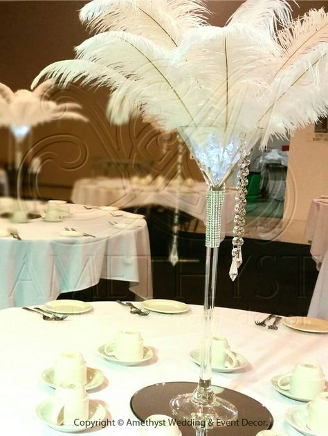 Great Gatsby martini glass centerpiece with ostrich plumes, crystals, gel beads, and submersible LED. I would add orchid stocks in between the plumes. Great centerpiece for a very fun wedding! Martini Centerpiece, 1920s Party Decorations, Martini Glass Centerpiece, Glass Wedding Centerpieces, Great Gatsby Theme, Feather Centerpieces, Light Pink Wedding, Amethyst Wedding, Wedding Event Decor