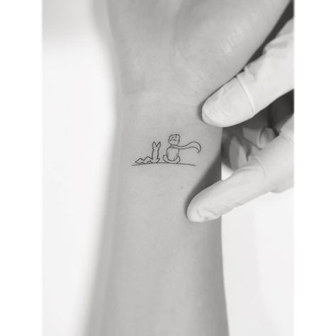 BW minimalist The Little Prince wrist tattoo  |  Artist @playground_tat2 on Instagram Petite Prince Tattoo, Prince Tattoo, A Small Tattoo, Little Prince Tattoo, Minimalist Tattoo Meaning, Prince Tattoos, Tattoo Diy, Cat Tattoos, Disney Tattoo