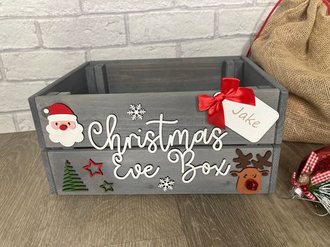 These personalised grey wooden crates with hand painted embellishments are perfect for those Christmas Eve treats such as PJ's, slippers, hot chocolate etc. These personalised boxes will really add to the excitement of the evening and sure to be treasured for years and years. Made from grey washed pine and measuring 23 x 31 x 15cm these sturdy boxes can be reused many times over. All of our products are handmade to order using the highest quality materials. These are individual wooden crates so some knots and blemishes are unavoidable. Some basic assembly required on receipt, (tools required Phillips crosshead screwdriver). Posted flat for ease of shipping and to avoid damages. Diy Christmas Eve Box, Wooden Crates Christmas, Christmas Eve Crate, Wooden Christmas Eve Box, Xmas Eve Boxes, Personalised Christmas Eve Box, Christmas Eve Gift, Wood Gift Box, Grey Christmas