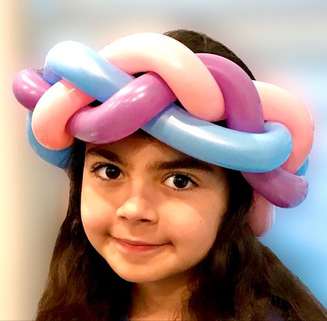 A little girl wears a braided balloon crown. The balloons are pink, purple and blue. Balloon Animal Ideas, Easy Balloon Animals, Crown Balloon, Balloon Hats, Balloon Crown, Princess Party Ideas, Ballon Art, Braid Crown, Diy Body Scrub Recipes