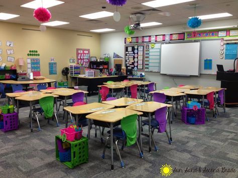 I love this cute and bright second grade classrooms!  Love the file crates to with each table's supply caddy and folders! Classroom Table Storage, Classroom Organization High School, Seat Sacks, Classroom Seating Arrangements, Desk Arrangements, Classroom Decor Middle, Classroom Arrangement, Colorful Classroom, Nice Room