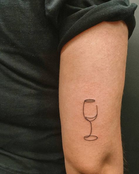 One line wine glass tattoo located on the tricep. Wine Glass Line Tattoo, Drinks Tattoo Ideas, Wine Tattoo Small, Wine Tattoo Best Friend, Tiny Wine Glass Tattoo, Wine Glass Tattoo Small, Cocktail Tattoo Small, Glass Of Wine Tattoo, Beer Tattoo Ideas