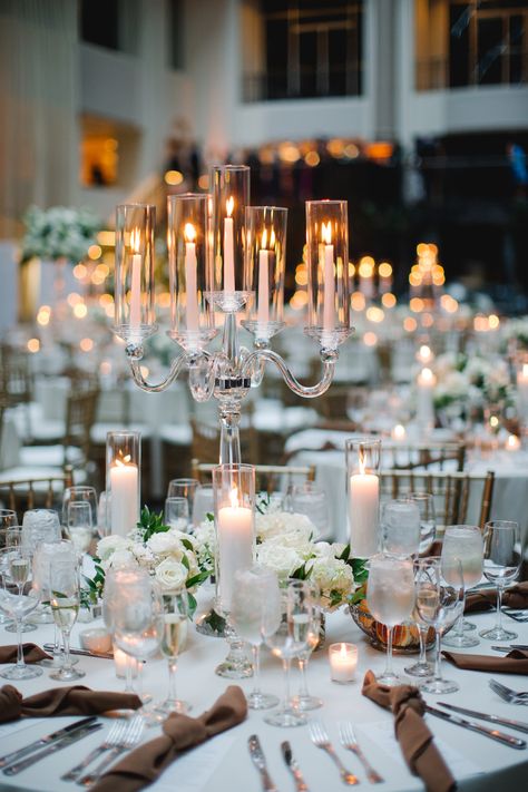 Classic arm crystal candelabra centerpiece with petite arrangements surrounding the base and more candlelight. PC: Asya Photography https://asyaphotography.com/ Candle Bar At Wedding, Large Candle Centerpieces Wedding, Candle Opera Centerpiece Wedding Ideas, Candles As Centerpieces, Chandelier Table Centerpiece, Candelabra Wedding Centerpieces Flowers, Candle Lit Wedding Tables, Tall Candelabra Wedding Centerpieces, Candelabras Wedding Centerpieces