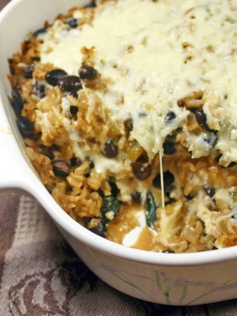 This black bean and brown rice casserole is meat-free, super tasty, and so easy to make! It's packed with flavor and melty cheese for a hearty, satisfying dish. Black Beans And Brown Rice Recipe, Brown Rice Casserole Recipes, Baked Brown Rice, Meat Casserole, Cheese Rice, Rice Casserole Recipes, Lentils And Rice, Brown Rice Casserole, Brown Rice Recipes