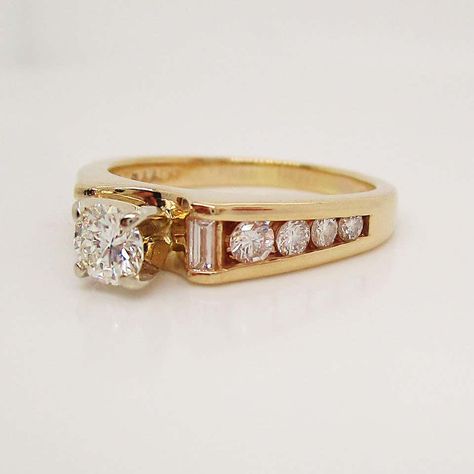 For Sale on 1stDibs - This absolutely beautiful ring is in 14k yellow gold and has a stunning collection of baguette and round diamonds to accent the brilliant white round center 80s Style Engagement Rings, Thick Gold Band Wedding Ring, Modern Vintage Engagement Rings, Antique Gold Engagement Ring, Vintage Engagement Ring Styles, Unique Vintage Engagement Rings, Victorian Style Engagement Ring, Antique Engagement Rings Victorian, Gold Antique Engagement Rings