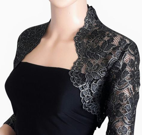 Excellent quality soft, thick, heavy corded lace Bolero in either black and gold or black and silver with 3/4 sleeves Would enhance any evening dress for that special occasion Luxury Elegant Semi-formal Jacket Dress, Luxury Semi-formal Elegant Jacket Dress, Luxury Black Semi-formal Outerwear, Luxury Long Sleeve Jacket Dress For Evening, Woman’s Lace Dresses And Jackets, Luxury Black Dress With Lace Collar, Luxury Formal Outerwear With Lace Trim, Luxury Capelet For Formal Occasions, Luxury Long Sleeve Cardigan For Formal Events