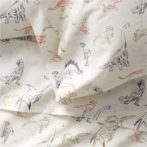 Welcome to the land before (bed)time, where roars turn to yawns and mighty creatures become sweet snuggle-o-saurs. Our Koro pillowcase is woven of cuddly organic cotton then printed with small dino illustrations, setting a cozy and colorful stage for little ones to dream of prehistoric places and friendly dino faces. (Trust us: Kids will go wild for this bedding collection.)     Multicolor dinosaur illustrations on white background  100% organic cotton  Pillowcases sold individually  Machine was Dinosaur Sheets, Kids Bed Sheets, Dinosaur Wall Decals, Kids Sheets, Kids Pillow Cases, Quilted Baby Blanket, Dinosaur Illustration, Organic Cotton Sheets, Quilted Duvet Cover