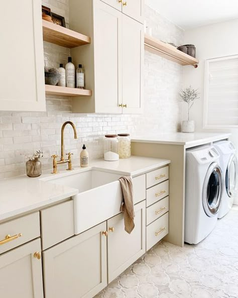 Laundry Room Finishes, Modern Coastal Laundry Room Ideas, Classic Laundry Room Design, Laundry Room Beige Cabinets, Transitional Laundry Room Design, Laundry Wall Design, Laundry Room Floating Shelves Over Sink, Mediterranean Laundry Room Design, Cream Cabinets Laundry Room