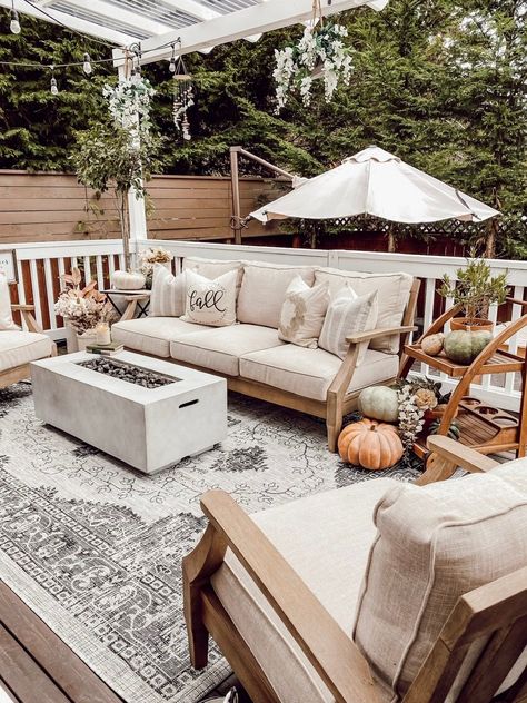 Create a cozy fall deck or patio in your backyard outdoor living space with cozy cottage style neutral beige sand color linen and wood outdoor furniture, a charcoal grey vintage floral farmhouse outdoor area rug from Boutique Rugs, a propane fire pit / concrete gas firepit, fairytale pumpkins and rustic earthy faux fall floral stems. - Rain and Pine #fallfarmhousedecor #falldecor #outdoorliving #backyard #patiodecor #cottagedecor #farmhousedecor #cozydecor #neutraldecor #fallpatiodecor Fairytale Pumpkins, Fall Patio Decor, Fall Deck, Fall Patio, Boutique Rugs, Floral Farmhouse, Farmhouse Patio, Outdoor Fire Pit Table, Rectangular Fire Pit