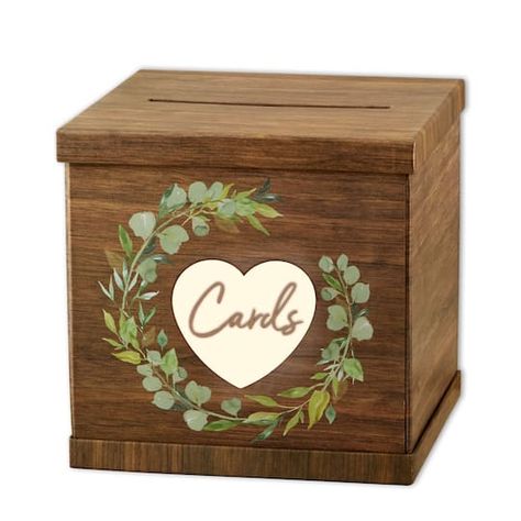 "Buy Kate Aspen Rustic Brown Wood Card Box at Michaels. com. Receiving gifts and cards is one of the sweetest ways guests show their support for your new marriage. Rustic Brown Wood Card Box by Kate Aspen is functional, cute décor for your next wedding or party. The wedding card box has a faux wood print allowing it to fit in with all the décor you already have put together. Green leaves make up the wreath that is found in the middle of the top of the box. In the center of the wreath is a pink t Card Box Design, Wood Card Box, Bridal Gift Box, Beautiful Wooden Boxes, Wedding Card Box, Wood Card, Moving Gifts, Cursive Font, Card Box Wedding