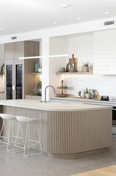 a neutral contemporary kitchen with light blue cabinets, a backsplash and a hood covered with white textural tiles and a ribbed kitchen island Light Blue Cabinets, White Scandinavian Kitchen, Contrasting Kitchen Island, Stone Kitchen Island, Contemporary White Kitchen, Curved Kitchen Island, Dark Green Kitchen, Neutral Contemporary, Curved Kitchen