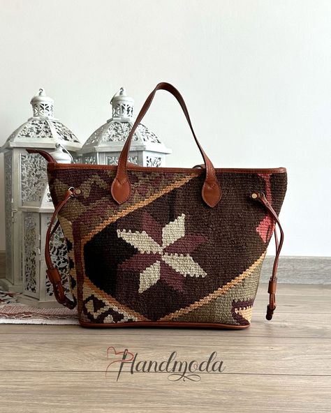 "This colorful and practical handmade Turkish Kilim hand bag is one of our unique collection of top quality hand-woven vintage bags that combines Turkish rich culture and modern design. The Turkish Kilim wool carpet are sourced from various regions of Turkey. Each of our handwoven old rugs is different and you end up with a unique vintage bag, that really stands out everywhere you go. All our products are eco-friendly, no synthetic fibers and chemicals are used. We use best genuine leather, YKK zippers and brass hardware in the manufacturing of our Kilim products. If you want a piece of art that has a rich history of stories and emotions, our bohemian bags are the right choice for you. SIZE: L44cm H30cm W16cm L17.5″ H12″ W6″ ITEM DETAILS: - 100% handmade - Handwoven old Kilim rug - High qu Mini Sling Bag, Into The West, Kilim Bag, Kilim Pattern, Bohemian Bags, Carpet Bag, Rug Texture, Handwoven Fabric, Rug Bag