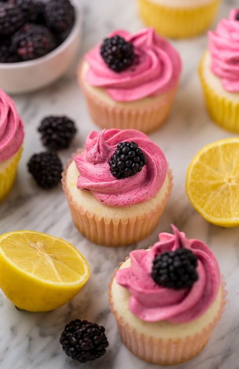 Fluffy Lemon Cupcakes are topped with BLACKBERRY Buttercream! These Lemon Blackberry Cupcakes are so pretty and always a showstopper. Their refreshing flavor makes them perfect for Spring and Summer celebrations! Moist Lemon Cupcakes topped with Fluffy Blackberry Buttercream Fact: I'm a little cupcake obsessed this Summer. Cannot get enough of them! Doesn't matter if they're Super Blackberry Cupcakes, Blackberry Buttercream, Berry Cupcakes, Lemon Recipe, Lemon Cupcakes, Cupcake Flavors, Cheesecake Brownies, Treat Recipes, Sweet Breads