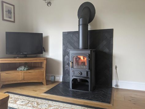 Slate Tile Wood Stove Surround, Tiling Behind Log Burner, Wood Stove Surround Corner, Stove Corner Ideas, Wood Stove Heat Shield, Earthy House, Herringbone Fireplace, Wood Stove Surround, Wood Stove Wall