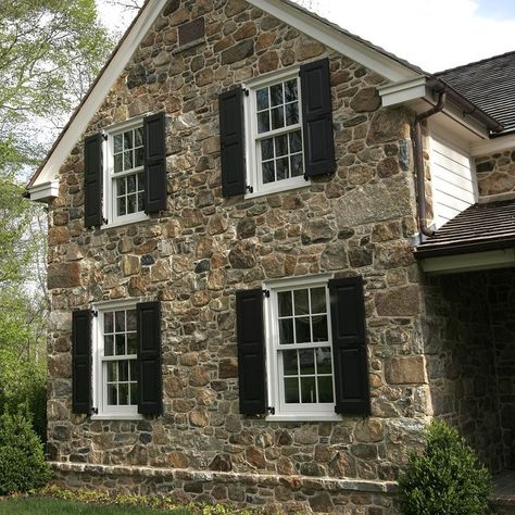 I'd love to replace the cedar that needs constant repainting on our house with stone like this! Chester Springs by Peter Zimmerman Architects Stone And Brick House Exterior, Cottage House Exterior, Stone Exterior Houses, Black Shutters, House Shutters, Stone Farmhouse, Stone Cottages, Old Stone Houses, Stone Facade