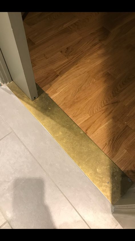 Brass Threshold Brass Strip Floor, Wood Threshold Ideas, Brass Threshold Strip, Metal Flooring Transition, Flooring Threshold Transition, Creative Floor Transitions, Brass Threshold Transition, Metal Threshold Transition, Transitions Between Tile And Wood Floors