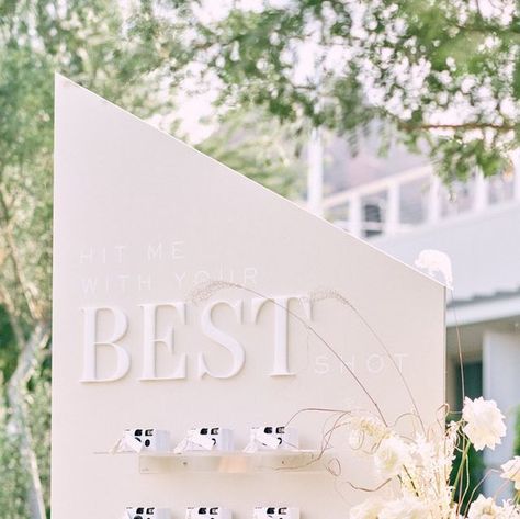 Details, Darling on Instagram: "Hit me with your BEST shot ——— Our client Chandler is an incredible photographer herself, so it was only fitting that their guests found their names + table assignments on these white disposable cameras. They grabbed a camera, found their seat + captured the sweetest photos throughout the evening 🤍 ⠀⠀⠀⠀⠀⠀⠀⠀⠀ Photo: @brandonkiddphoto Video: @penweddings Planning & Design: Kenzie of @detailsdarling @kenzie_swift Venue: @mountainshadowsaz Rentals: @eventrentsaz @ Details Darling, Evening Photo, Camera Wall, Disposable Cameras, Table Assignments, Disposable Camera, Wall Ideas, Instagram Accounts, Lei