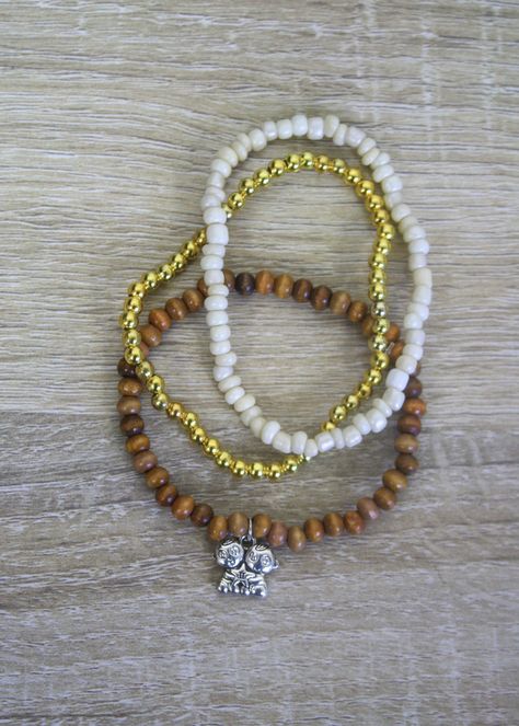 This unique bracelet is the star of the show! Its round wood beads and silver Gemini charm make a stylish statement - perfect for the trendsetter or traditionalist. Plus, you can mix and match with the stack option of an accompanying white glass seed bead and gold metal round bead bracelet! Get the Gemini Bracelet stack today and you'll be sure to be the life of any gathering! Gemini Bracelet, Unique Bracelets, Bracelet Stack, Bead Bracelet, Seed Bead, The Star, Wood Beads, White Glass, Trend Setter