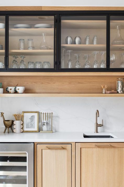 This stunning custom kitchen includes two tone cabinets and a wet bar in the breakfast nook. The white oak cabinetry is contrasted beautifully with the black framed cabinet fronts and SW Cyberspace cabinetry. Additionally, the shelf under the cabinetry adds a small detail that really elevates the wet bar. Sw Cyberspace, Kitchen Two Tone, Two Tone Kitchen Cabinets Color Combinations, White Coastal Kitchen, Wet Bar Cabinets, Crockery Cabinet Design, Rustic Industrial Kitchen, Kitchen Coastal, One Wall Kitchen