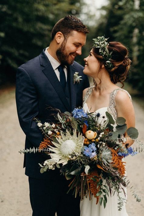 This camp wedding features some of the most incredible exotic flowers we've ever seen | image by Kaihla Tonia Photography #rusticweddinginspo #campweddinginspo #fallweddinginspo #weddingphotoinspiration #weddingphotoideas #weddingportrait #couple #cutecouple #coupleportrait #firstlook Eucalyptus Wedding Bouquet, Protea Wedding, Bouquet Champetre, Protea Bouquet, Bouquet Images, Tulip Wedding, Orange Bouquets, Cascading Wedding Bouquets, Peony Bouquet Wedding