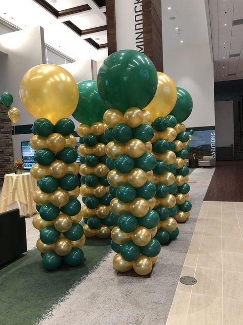 Fast Stack balloon columns with 3 foot Topper- by Balloon Art by Merry Makers Dark Green And Gold Balloon Arch, Green And Gold Balloon Columns, Green And Gold Balloons Decoration, Green And Gold Prom Decorations, Green And Gold Birthday Party Decor, Balloon Column Ideas, Column Ideas, Balloon Tower, Gold Graduation Party