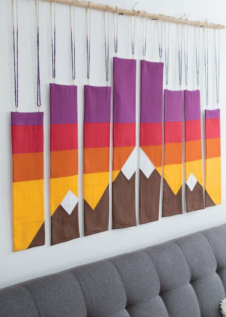 Amazing wall hanging! I can't wait to make it because the mountains outside are snow capped just as in this quilted wall hanging! The book was created by the designers at FaveQuilts and features 11 projects for every skill level. Each modern project makes unique use of traditional quilting piecing techniques with construction ranging from "I can do it in my sleep" to "Wow - how did they do that?". #wall #wallart #walldecor #walldecoration #modern #moderndesign #wallhanging #patchwork #quilts Scenery Quilts, Southwest Bedroom, Quilt Hanging, History Of Quilting, Modern Quilting Designs, Mountain Quilts, Hanging Quilts, Yellow Quilts, Quilt Modernen