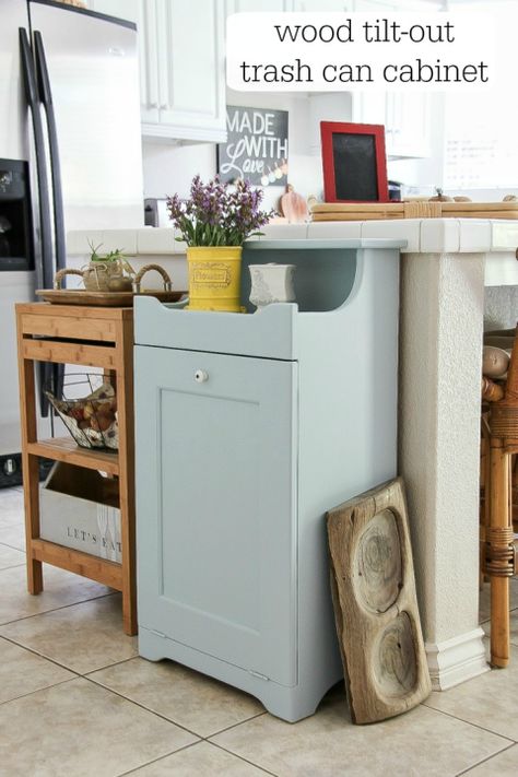 Often crafted from wood, these clever concealers add a country-chic accent to a kitchen, and the handheld tilt-out design means your bin is always easily within reach. This blogger repainted a cabinet she found a thrift store, but you can also DIY your own from scratch. Get the tutorial at Create Celebrate Explore » Kitchen Garbage Can Storage, Hidden Trash Can Kitchen, Hide Trash Cans, Garbage Can Storage, Can Cabinet, Trash Can Cabinet, Hidden Kitchen, Kitchen Trash Cans, Kitchen Renovation