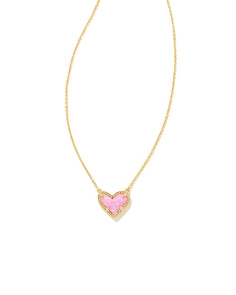 Feminine yet flirty with an asymmetrical design, the Ari Heart Gold Pendant Necklace in Bubblegum Pink Kyocera Opal is our new obsession. Layer it or let it shine on its own—either way you'll be hearing "Where'd you get that?" every time you wear this pendant necklace out. Metal 14k Yellow Gold Over Brass Material Bubblegum Pink Kyocera Opal Closure Lobster Clasp Size 15" chain w/ 2" extender, 0.57"L X 0.49"W pendantDue to the one-of-a-kind nature of the medium, exact colors and patterns may var Heart Pendant Necklace Gold, Short Pendant Necklace, Preppy Jewelry, New Obsession, Kendra Scott Necklace, Let It Shine, Kendra Scott Jewelry, Asymmetrical Design, Shine On