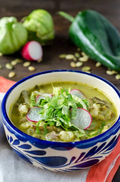 Vegan Pozole Verde, a traditional Mexican soup your family will love. Mushroom are stewed in a poblano-tomatillo sauce then topped with avocado, radish and lettuce. The best part is that it's gluten-free too! #veganmexican #vegansoups #glutenfree