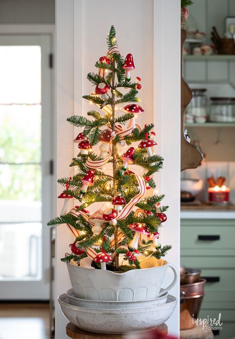 small Christmas tree decorated with glass mushroom ornaments. Mushroom Tree Topper, Christmas Mushrooms Decoration, Tiny Christmas Tree Ideas, Christmas Tree For Small Spaces, Mini Christmas Tree Ideas, Small Space Christmas Tree, Christmas Mushroom, Mushroom Christmas Tree, Mushroom Tree