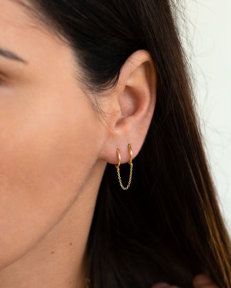 "Two dainty huggie hoops are connected by a delicate chain in this double piercing earring design. Dress it up or down, this simple double huggie hoop earring is perfect to add some layering to your ear stack. ♦ Sold singly (1 piece) or as a pair (2 pieces). * D E T A I L S * ∙ Material: .925 Sterling Silver or 18K Gold Plated over .925 Sterling Silver  ∙ Inner diameter: 9mm     Chain length: 2.5cm ∙ Hypoallergenic & nickel-free * P A C K A G I N G * ∙ All jewelry is sent out beautifully package 2nd Ear Piercing, 3 Lobe Piercings, Double Piercing Earring, Piercing Lobe, Tiny Gold Earrings, Double Ear Piercings, Ear Lobe Piercings, Huggie Earrings Gold, Double Earrings