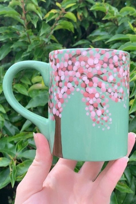 Hand painted cherry blossom themed mug! Hand painted, glazed and kilned by yours truly making this beautiful mug one of a kind! Great for all those nature lovers out there! Treat yourself or a loved one today with a mug that with inspire peace and tranquility and transport you to a magical place from right there in your sitting room! Free UK P&P + US shipping! Follow us on Instagram @mistymagpieshop Cherry Blossom Ceramic Painting, Pottery Painting Mug Ideas Easy, Paint Your Own Mug Ideas, Simple Mug Painting Ideas, Paint A Mug Ideas, Cute Pottery Painting Ideas Mugs, Hand Painted Pottery Mugs, Pottery Painting Mug Ideas, Pottery Designs Painted