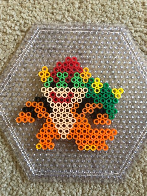 Super Mario Bowser villain perler bead craft design Perler Beads Disney Villains, Mario Melty Bead Patterns, Mario Characters Perler Beads, Mario Melty Beads, Perler Bead Bowser, King Boo Perler Beads, Perler Designs Ideas, Nerd Perler Bead Patterns, Unique Perler Bead Ideas