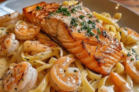 Indulge in this creamy Salmon and Shrimp Alfredo recipe. Rich seafood, tender pasta, and a luscious Alfredo sauce. Perfect for any dinner! Salmon And Shrimp Alfredo Pasta, Cajun Salmon And Shrimp Alfredo, Salmon Alfredo Pasta Recipes, Seafood Alfredo Pasta, Salmon And Shrimp Alfredo, Salmon Alfredo Pasta, Pasta Salmon, Seafood Alfredo, Shrimp Stuffed Mushrooms