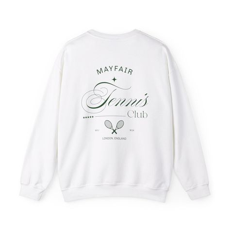 Introducing the Mayfair London Tennis Club Crewneck - because why settle for ordinary when you can channel the exclusivity of Mayfair? Featuring the postcode of the chicest corners of London, this crewneck is the perfect mix of sporty and rich, ideal for those who spend weekends at the court and nights at members-only clubs. Whether you're smashing aces or sipping martinis, this luxe sweatshirt lets you flex your love for tennis and London's most elite scene. Made from a blend so soft it feels like a hug from your favorite tennis partner, it's perfect for those crisp mornings at the club, lazy afternoons on the porch, or even a quick coffee run (because, let's face it, who has time for tennis before their latte?). And don't worry, it's machine washable--ideal for cleaning up any accidental Sporty And Rich Crewneck, Sporty And Rich Sweatshirt, Logo Vert, Quick Coffee, Mayfair London, London Clubs, Tennis Club, Tennis Clubs, Green Logo