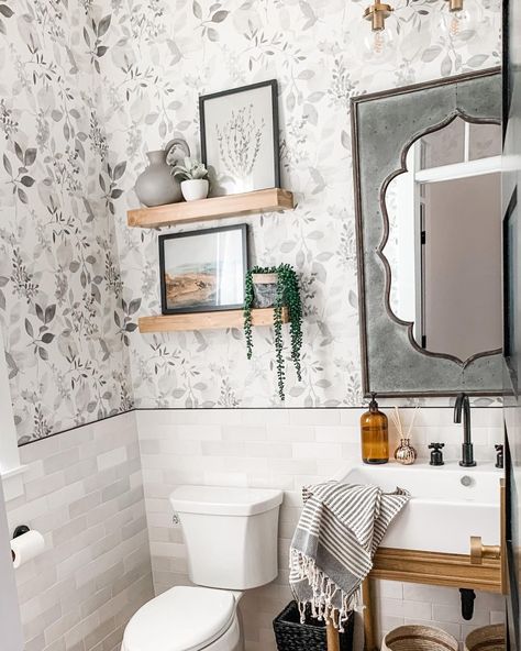 Cloe tile bathroom half wall is paired with gray and white floral wallpaper. Wood floating shelves are installed over a white toilet. A rustic gray mirror rests above a white farmhouse sink on top of a wood vanity. Cloe Tile Bathroom, White Floating Shelves Kitchen, White Kitchen Drawers, Bonnie Ryan, Modern Half Bath, Wallpaper In Bathroom, Cloe Tile, Weekend Well Spent, Light Grey Kitchen Cabinets