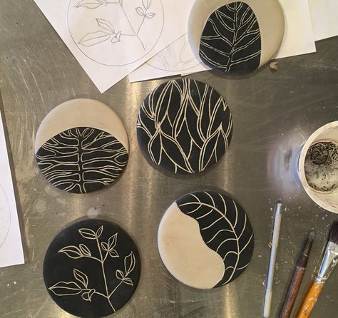 You will create four tiles using the sgraffito technique. The tiles can be used as coasters or wall decor. I will assist you in designing a suitable graphic image on tracing paper before class or you may use one of my botanical images like the sample. Here is a description of the process: On just p Sgraffito Coasters, Sgraffito Ceramics Ideas, Plate Art Ideas, Botanical Images, Sgraffito Technique, Coaster Art, Pottery Painting Designs, Keramik Design, Tracing Paper