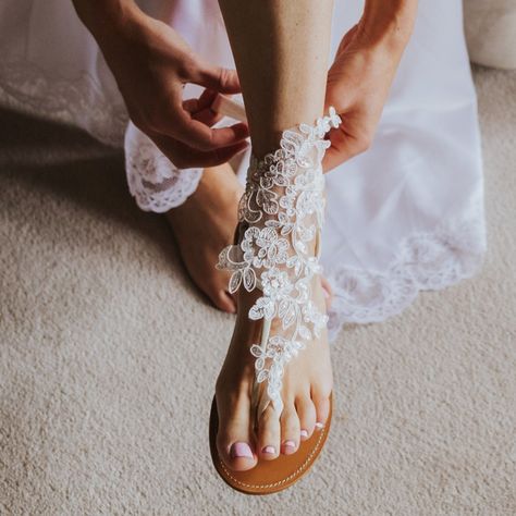 39.99 USD French lace bridal barefoot sandals offer a touch of sophistication, married with bohemian sensibilities, to give you a remarkably comfortable alternative to traditional shoes while walking thru the sand to marry the man of your dream. Featuring a French lace, shiny sequins and a really comfortable elastic ribbon, these boho wedding sandals are a popular choice for beach weddings barefoot brides. Available in a choice of two colors will complement your big day outfit splendidly. One… Boho Barefoot Sandals, Barefoot Sandals Beach Wedding, Comfy Wedding Shoes, Bridal Foot Jewelry, Lace Barefoot Sandals, Bride Sandals, Boho Wedding Shoes, Barefoot Sandals Wedding, Beach Wedding Sandals