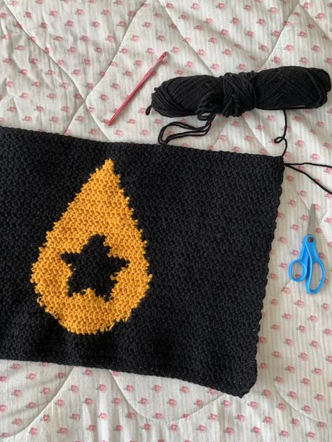 A crochet panel (sample swatch, pattern test) based on a useful pixel grid pattern of Conan Gray's iconic teardrop star symbol from his 3rd studio album "Found Heaven." The pattern contains a black star with a yellow teardrop surrounding it and a black background. Great inspiration and guide for crochet and knit projects surrounding this musical album and its songs/concepts. Conan Gray Teardrop Star, Crochet Conan Gray, Conan Gray Crochet, Found Heaven Conan Gray, Found Heaven, Crochet Teardrop, Crochet Messenger Bag, Crochet Hdc, Grey Tapestry